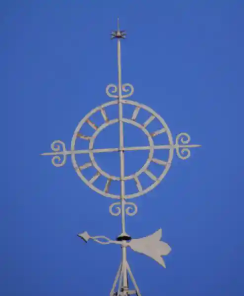 Cross inside a solar disc on top of a steeple